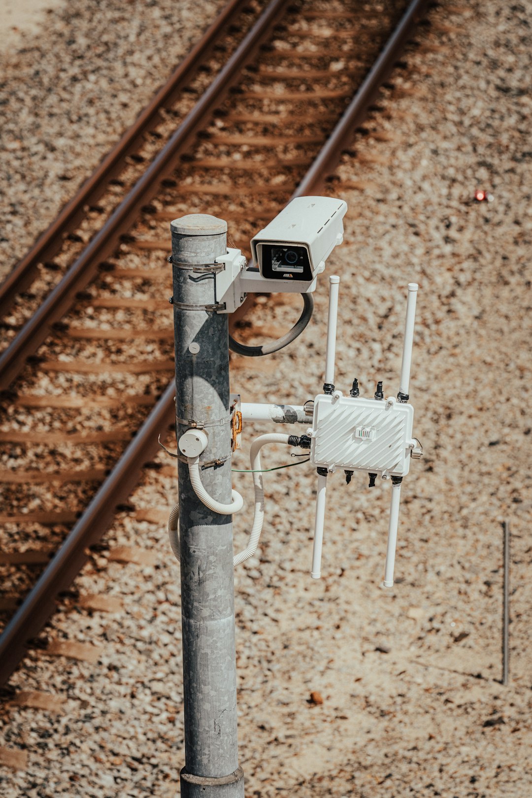 a-security-camera-attached-to-a-metal-pole-qbfqxyslowq